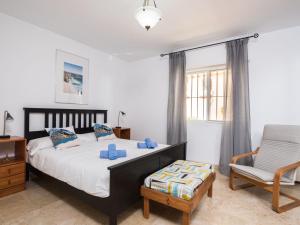 a bedroom with a bed and a chair at Apartment Marina Bay-2 by Interhome in Estepona