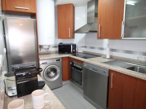 a kitchen with a sink and a dishwasher at Apartment Vila Park by Interhome in Cala de Finestrat +12 photos