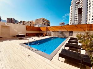 a swimming pool on the roof of a building at Gran Cavancha Suite in Iquique