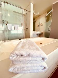 un asciugamano bianco appoggiato su una vasca da bagno in un bagno di Gran Cavancha Suite a Iquique