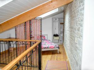 a staircase in a room with a stone wall at Holiday Home L'Ancienne Scierie by Interhome in Saint-Martin-sur-Armançon