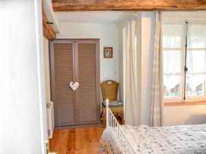 a bedroom with a bed and a closet with a door at Holiday Home L'Ancienne Scierie by Interhome in Saint-Martin-sur-Armançon +19 photos