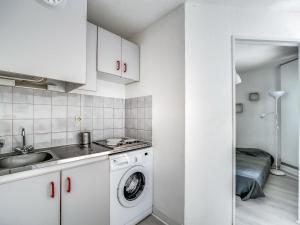 eine Küche mit einer Waschmaschine und einem Waschbecken in der Unterkunft Apartment Les Floralies II-7 by Interhome in Le Grau-du-Roi