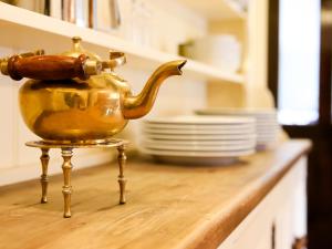 a golden tea kettle sitting on a counter in a kitchen at Ridge Hall in Chapel en le Frith