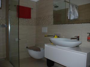a bathroom with a sink and a toilet and a shower at Apartment Saleggi Apt- 20 by Interhome in Locarno