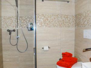 a shower with a red towel on a toilet in a bathroom at Apartment Saleggi Apt- 20 by Interhome in Locarno