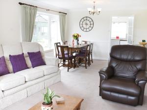 a living room with a white couch and a table at Glebeland in Bishops Castle