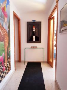 a hallway with a black rug and a picture of a giraffe at Rambla - Palma center in Palma de Mallorca