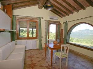 a living room with a table and a couch at Holiday Home Casale Belvedere by Interhome in Roccastrada