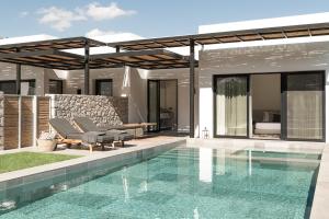 a villa with a swimming pool and a house at Casa Cook Rhodes (Adults Only) in Kolimbia