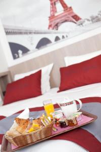 a tray of food on a bed with the eiffel tower at Saphir Grenelle in Paris