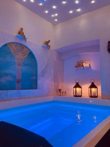 a large swimming pool in a room with a swimming pool at Palazzo Barbini Dimora Storica in Castiglione del Lago