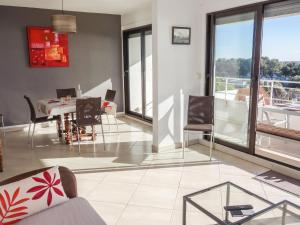 a living room with a table and chairs at Apartment Les Hauts de Fonsainte by Interhome in La Ciotat