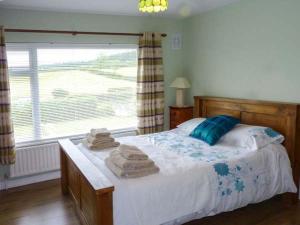 a bedroom with a bed with towels on it at Eileen's in Cloone