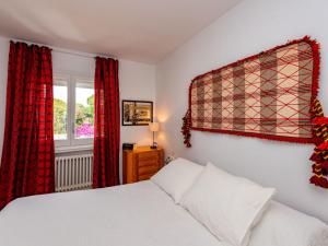 a bedroom with a white bed and a window at Apartment Acuario by Interhome in Sant Andreu de Llavaneres