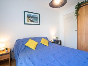 ビアリッツにあるApartment Le Prado by Interhomeのベッドルーム(青いベッド、黄色い枕付)