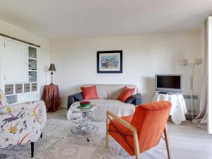 a living room with a couch and a table at Studio Les Corniches du Mont Canisy-3 by Interhome in Blonville-sur-Mer