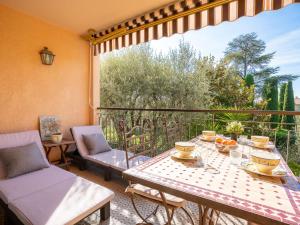 a patio with a table and chairs on a balcony at Apartment L'Orée de Vence by Interhome in Vence