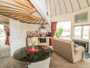 a living room with a table and a chair at Secret Island Yurt in Beckford