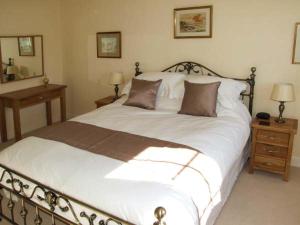 a bedroom with a large white bed and two night stands at Harris House in Ludlow