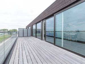 an empty balcony of a building with glass windows at Apartment Lakeside by Interhome in Bredene