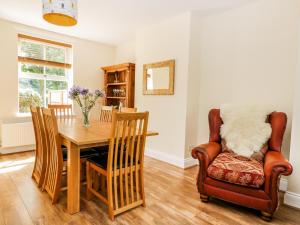 a dining room with a table and a chair at 2 Moor Farm Cottages in Flinton