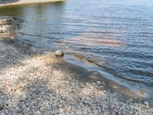 a body of water with rocks on the shore at Holiday Home Mäkrä 1 by Interhome in Kolinkylä