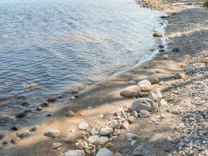 a group of rocks on the shore of a body of water at Holiday Home Mäkrä 1 by Interhome in Kolinkylä
