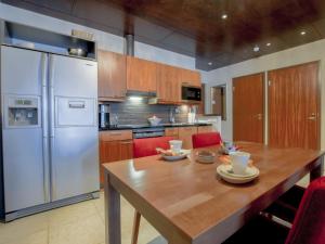 eine Küche mit einem Holztisch und einem weißen Kühlschrank in der Unterkunft Holiday Home Tahko spa junior suite orange b6 by Interhome in Tahkovuori