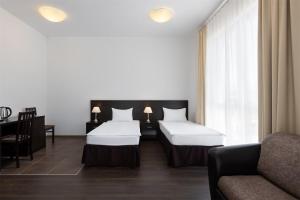 
two beds in a hotel room at Apart Hotel Imeretinsky - Pribrezhny Kvartal in Adler
