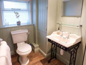a bathroom with a toilet and a sink at Clock View in Haworth