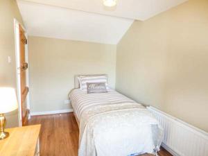 a bedroom with a bed in the corner of a room at Arfryn in Bethesda