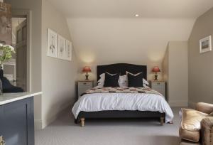 a bedroom with a bed with two night stands and two lamps at The Hideaway in Moreton in Marsh