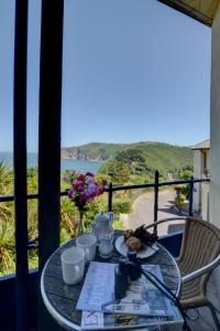 a table with food and a view of the ocean at Apartment The Orangery by Interhome in Lynton