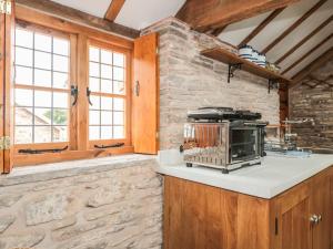 a kitchen with a counter with a toaster oven at The Cow Cott in Peterchurch