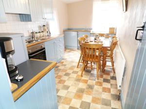 a kitchen with a table and chairs in it at Callaghan's in Kilkeel