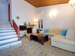 a living room with a couch and a table at Holiday Home Peter by Interhome in Prigradica