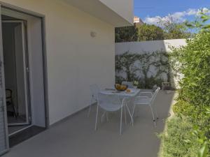 a patio with a table and chairs on a balcony at Apartment Talìa Luna by Interhome in Sampieri