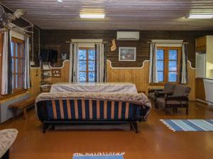 a bedroom with a large bed in a room at Holiday Home Palokärki by Interhome in Urimolahti