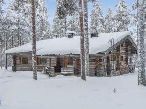 a log cabin in the woods in the snow at Holiday Home Lomapata by Interhome in Nissi
