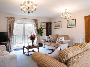 a living room with two couches and a tv at Riverdale in Shrewsbury