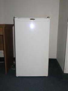 um frigorífico branco no canto de um quarto em Heritage Inn em Wahoo