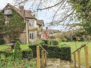 an old house with a garden in front of it at Hoath House in Chiddingstone