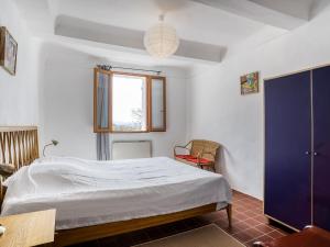 a bedroom with a bed and a window at Holiday Home Les Huppes by Interhome in Saint-Saturnin-les-Apt