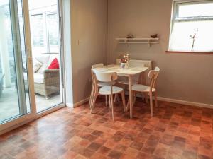 a small dining room with a table and chairs at Lamora in Cheddar