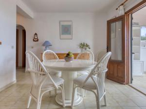 a white dining room with a white table and chairs at Holiday Home Peeters by Interhome in Calpe +15 photos