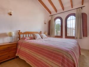 a bedroom with a large bed and two windows at Holiday Home Peeters by Interhome in Calpe