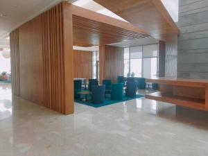 a lobby with blue chairs and tables in a building at Zephyr Agadir in Agadir