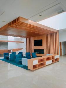 a living room with a table and blue chairs at Zephyr Agadir in Agadir