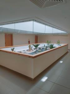 a lobby with a fountain with plants in it at Zephyr Agadir in Agadir